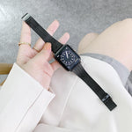 Steel replacement strap for Apple Watch shown on wrist with black watch face and band.